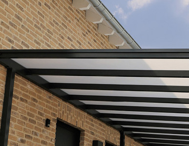 Moderne Überdachung mit transparenter Dacheindeckung aus Kunststoffplatten und stabiler Metallkonstruktion.